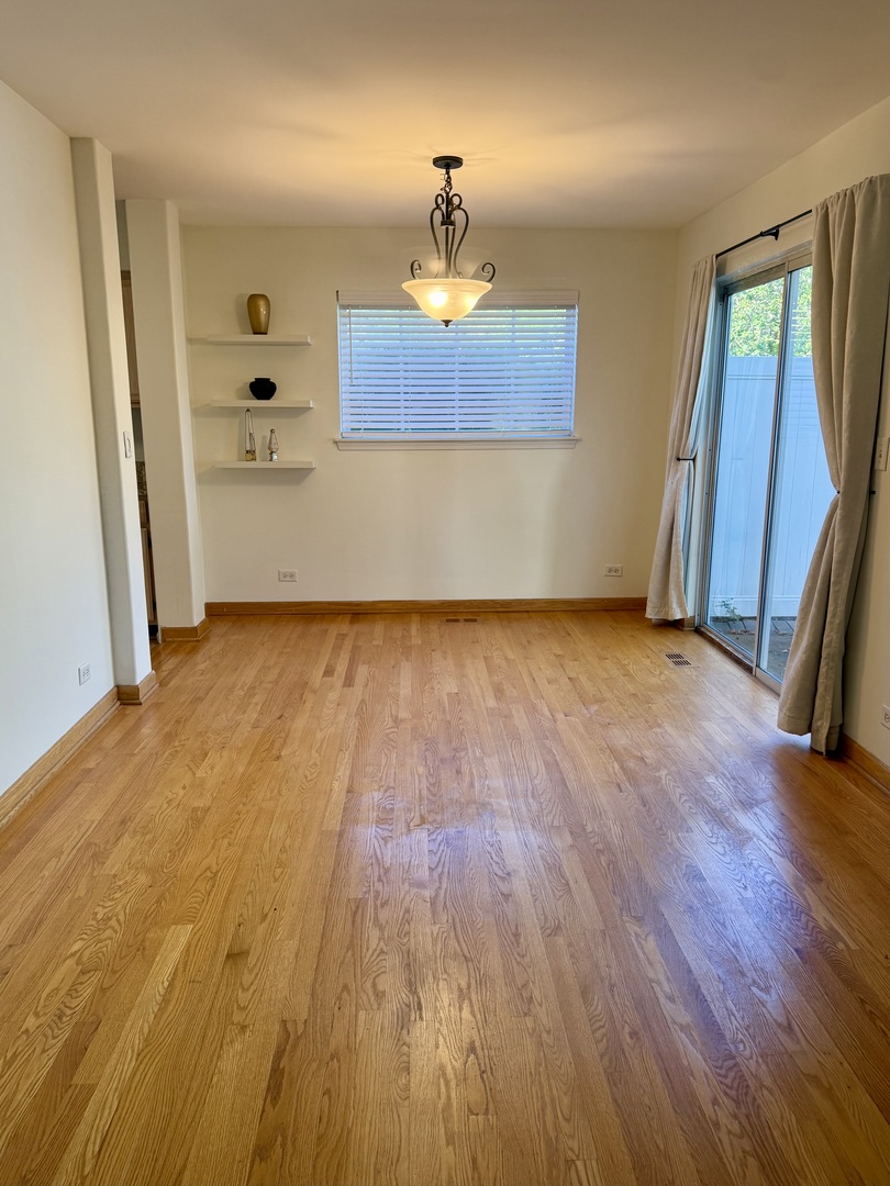 1198 Bristol Lane Buffalo Grove, IL 60089 - Photo 11 of 24 an empty room with wooden floor and a window
