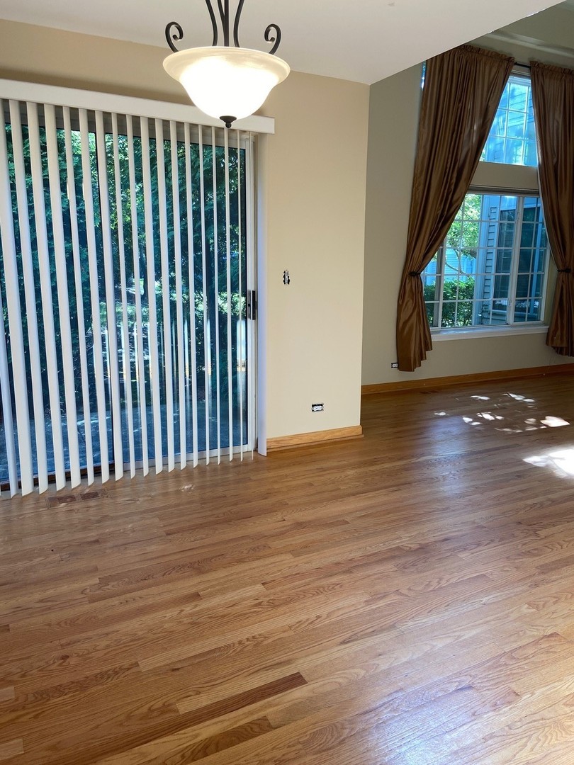 1198 Bristol Lane Buffalo Grove, IL 60089 - Photo 12 of 24 an empty room with wooden floor and windows