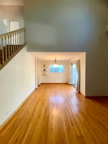 a view of a room with wooden floor
