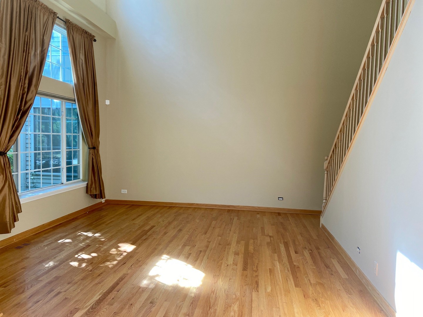 1198 Bristol Lane Buffalo Grove, IL 60089 - Photo 14 of 24 a view of an empty room with a window and wooden floor
