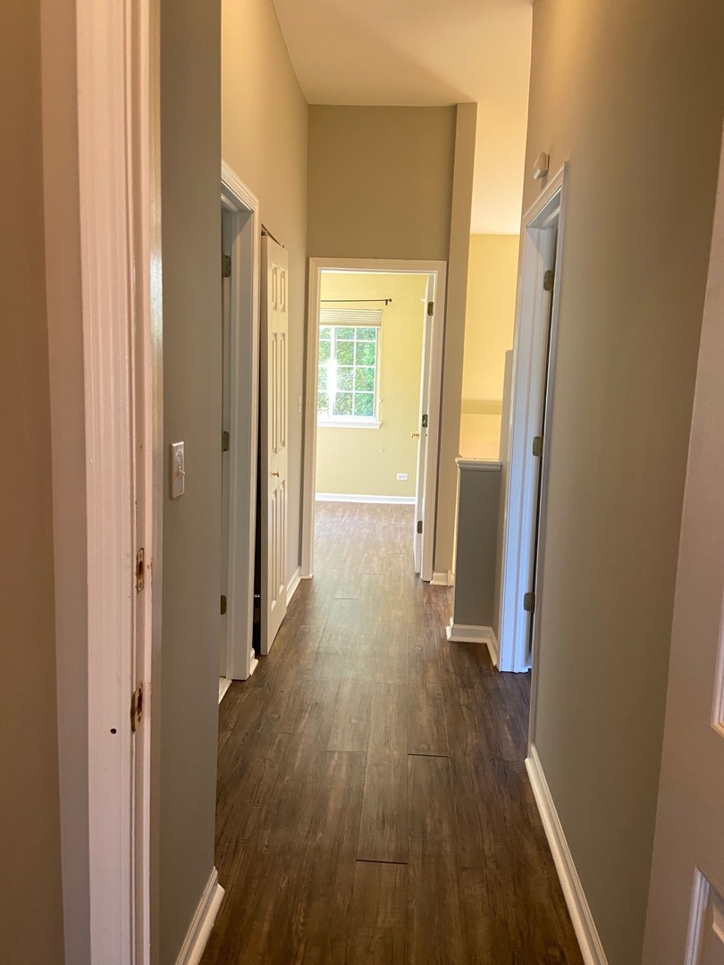 1198 Bristol Lane Buffalo Grove, IL 60089 - Photo 17 of 24 a view of a hallway with wooden floor