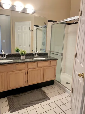 a bathroom with a double vanity sink and mirror