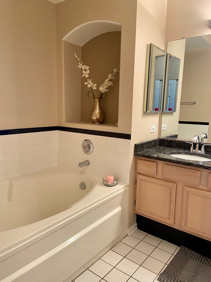1198 Bristol Lane Buffalo Grove, IL 60089 - Photo 20 of 24 a bathroom with a bathtub and a sink