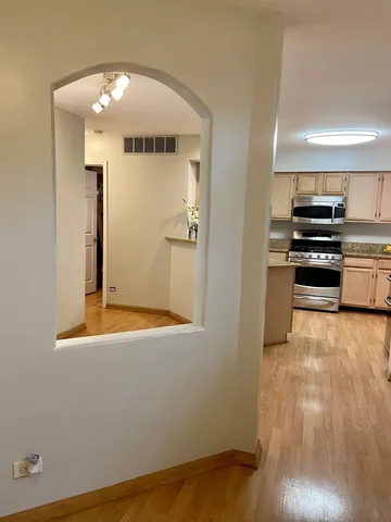a view of a kitchen with wooden floor