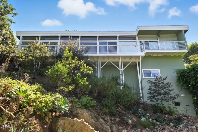 a view of a brick house with a yard