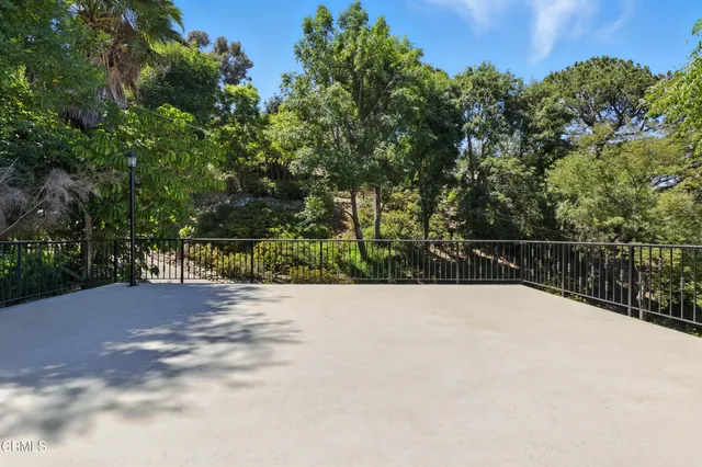 a view of a balcony with wooden fence