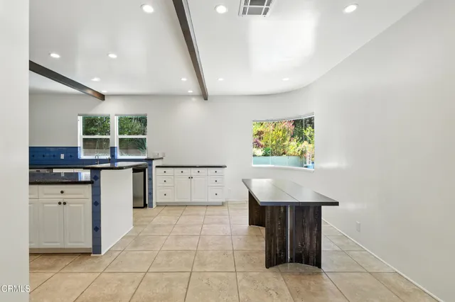 a kitchen with a sink window and cabinets