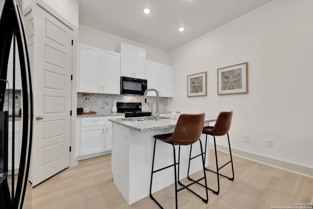 a kitchen with a stove cabinets and a refrigerator