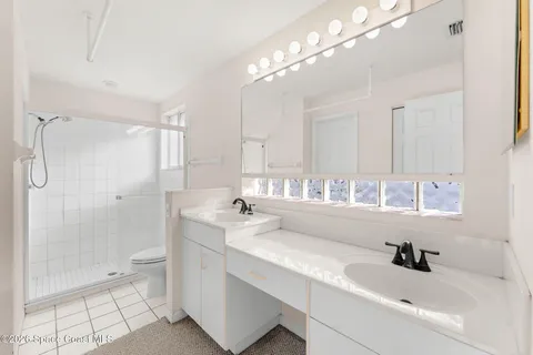 a view of a bathtub in a room next to a large window