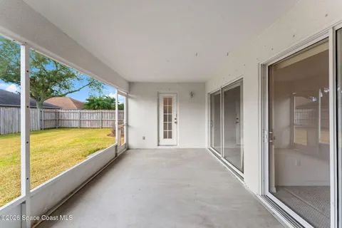 an aerial view of residential houses with outdoor space and ocean view