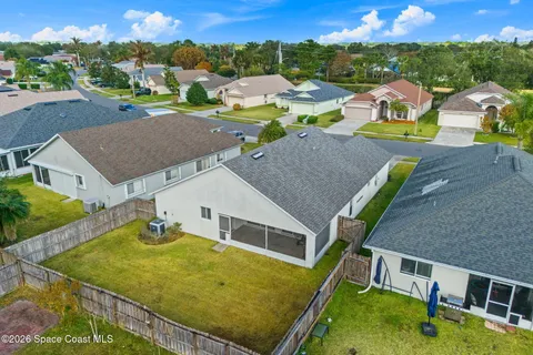 an aerial view of a house with a garden and trees