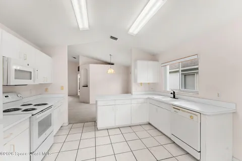 a kitchen with a sink cabinets and appliances