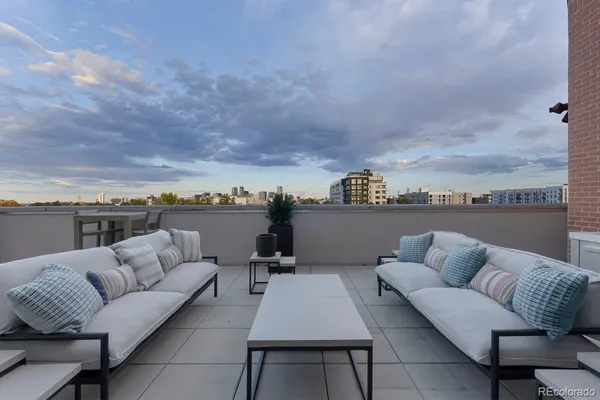 an outdoor living room with furniture