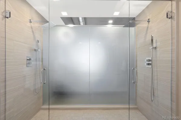a bathroom with a glass shower door