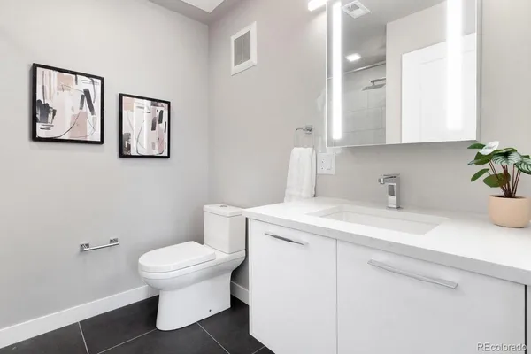 a bathroom with a sink toilet and vanity
