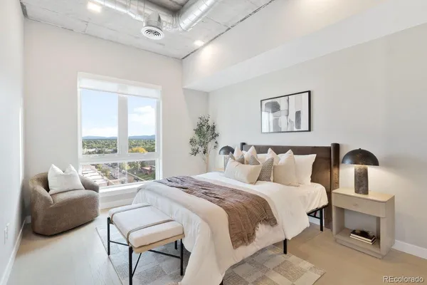 a bedroom with a bed and a couch