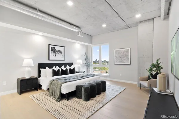 a bedroom with a large bed and a couch