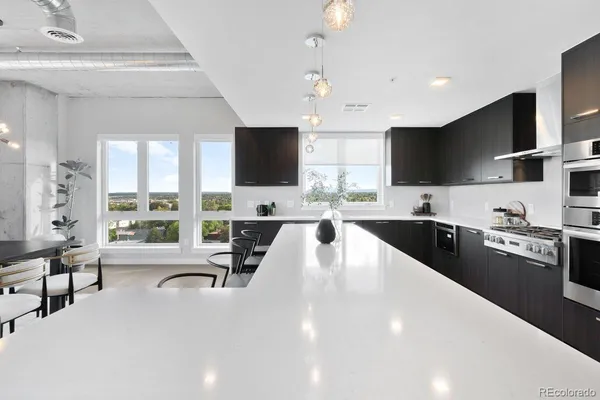a large kitchen with a large window and stainless steel appliances