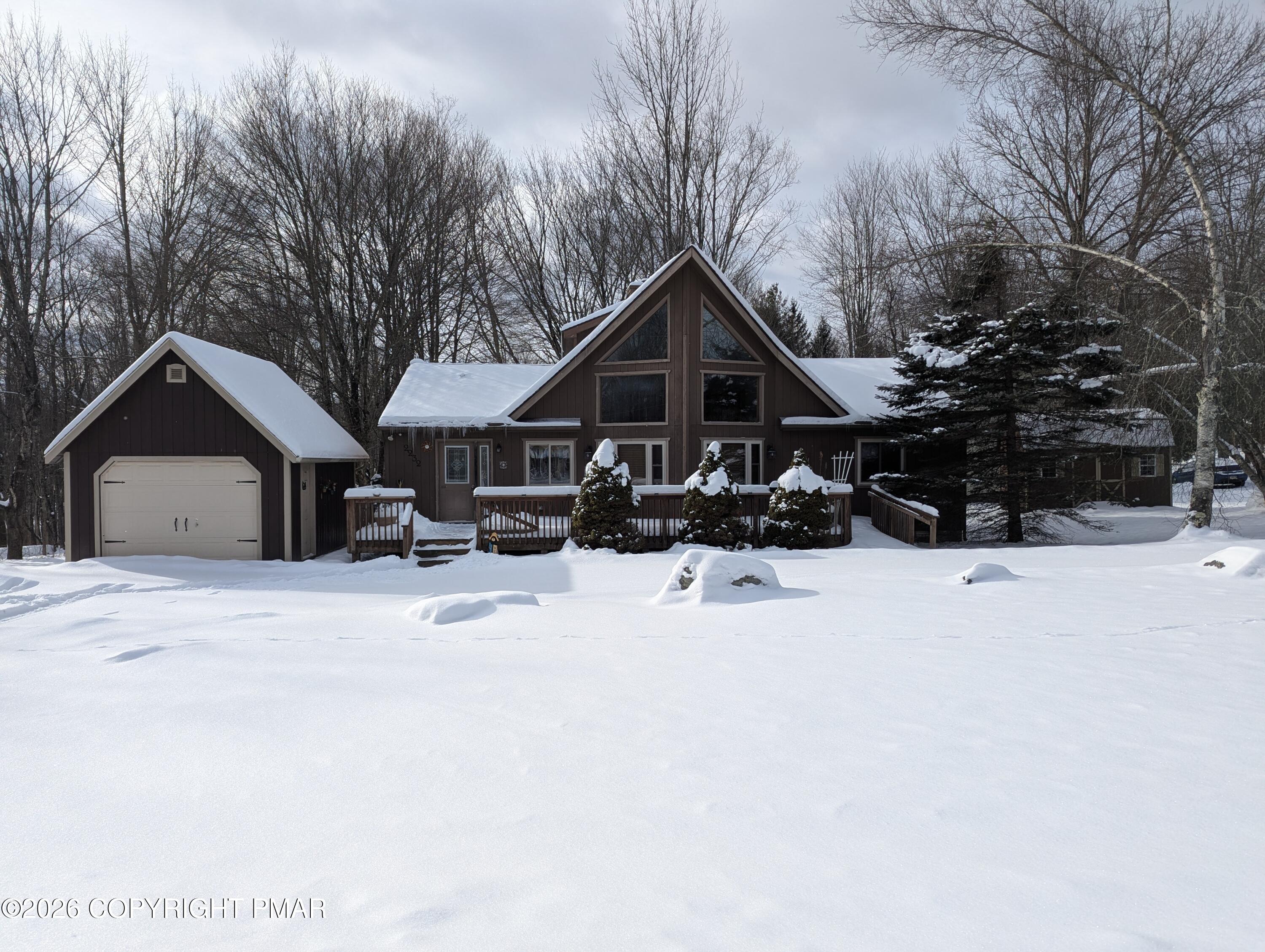 a view of a house with a yard covered in snow