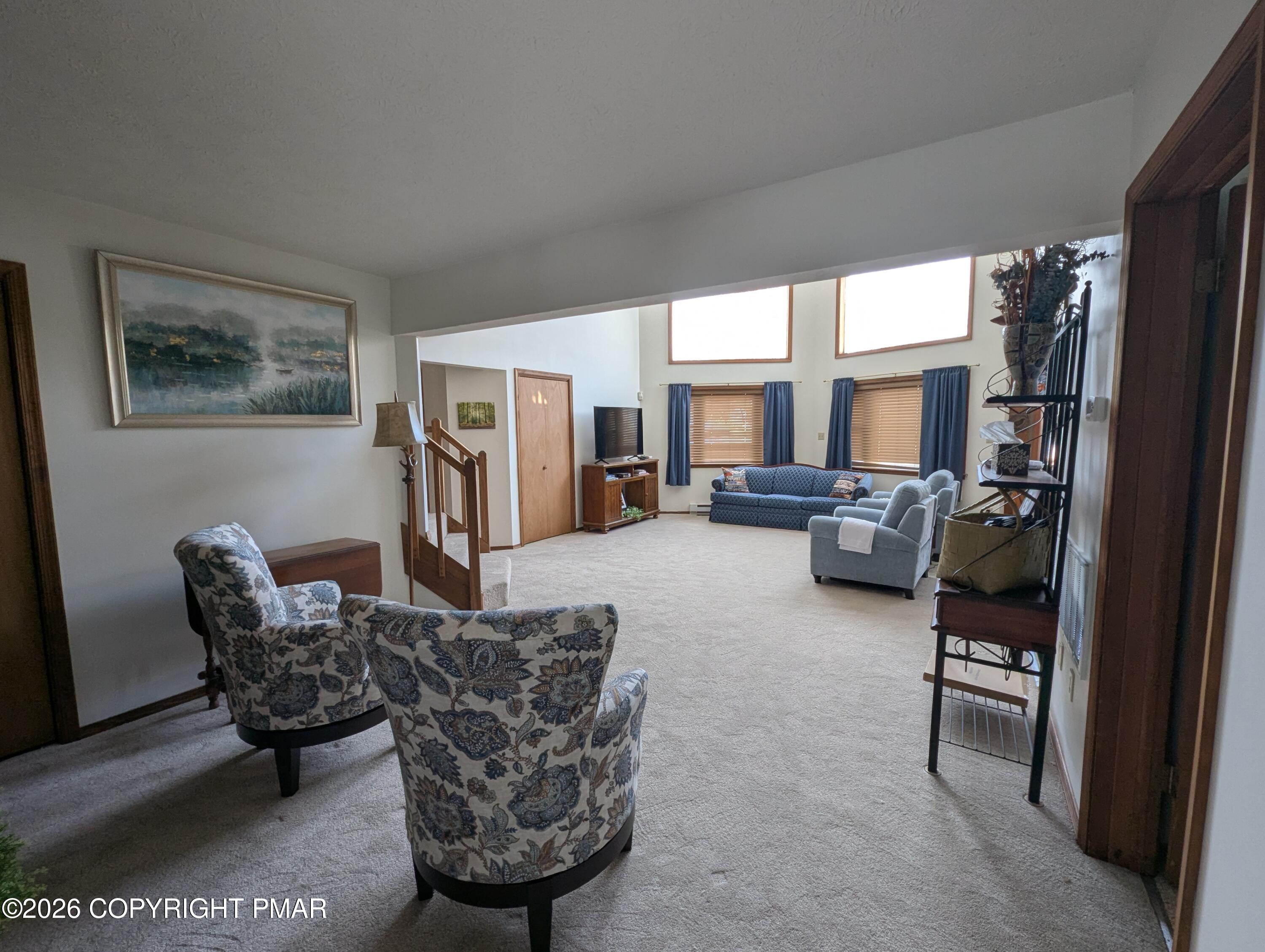 64 High Point Drive, Unit 2232 Lake Ariel, PA 18436 - Photo 11 of 12 a living room with furniture a large window and kitchen view