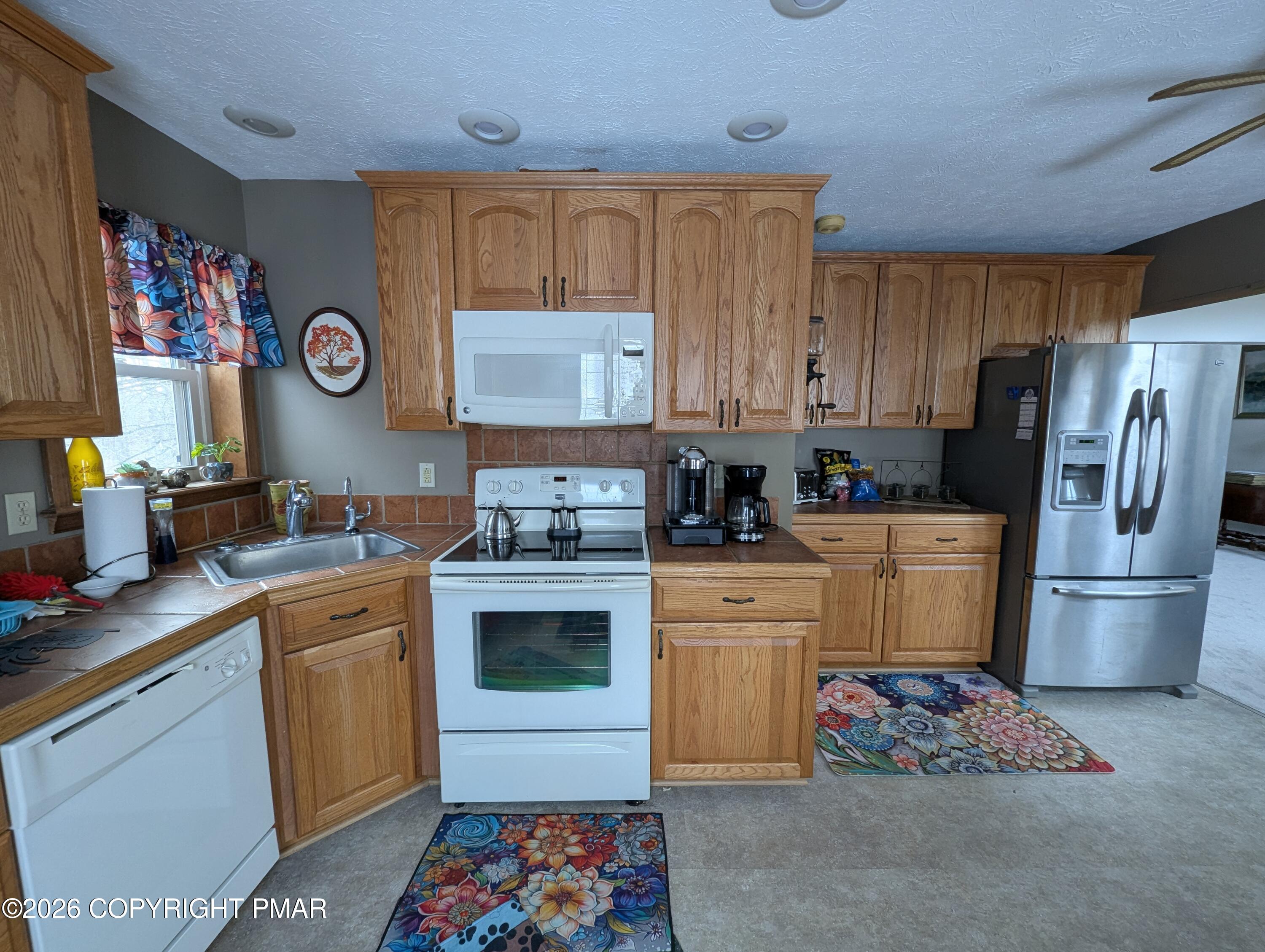 64 High Point Drive, Unit 2232 Lake Ariel, PA 18436 - Photo 6 of 12 a kitchen with a sink cabinets and stainless steel appliances