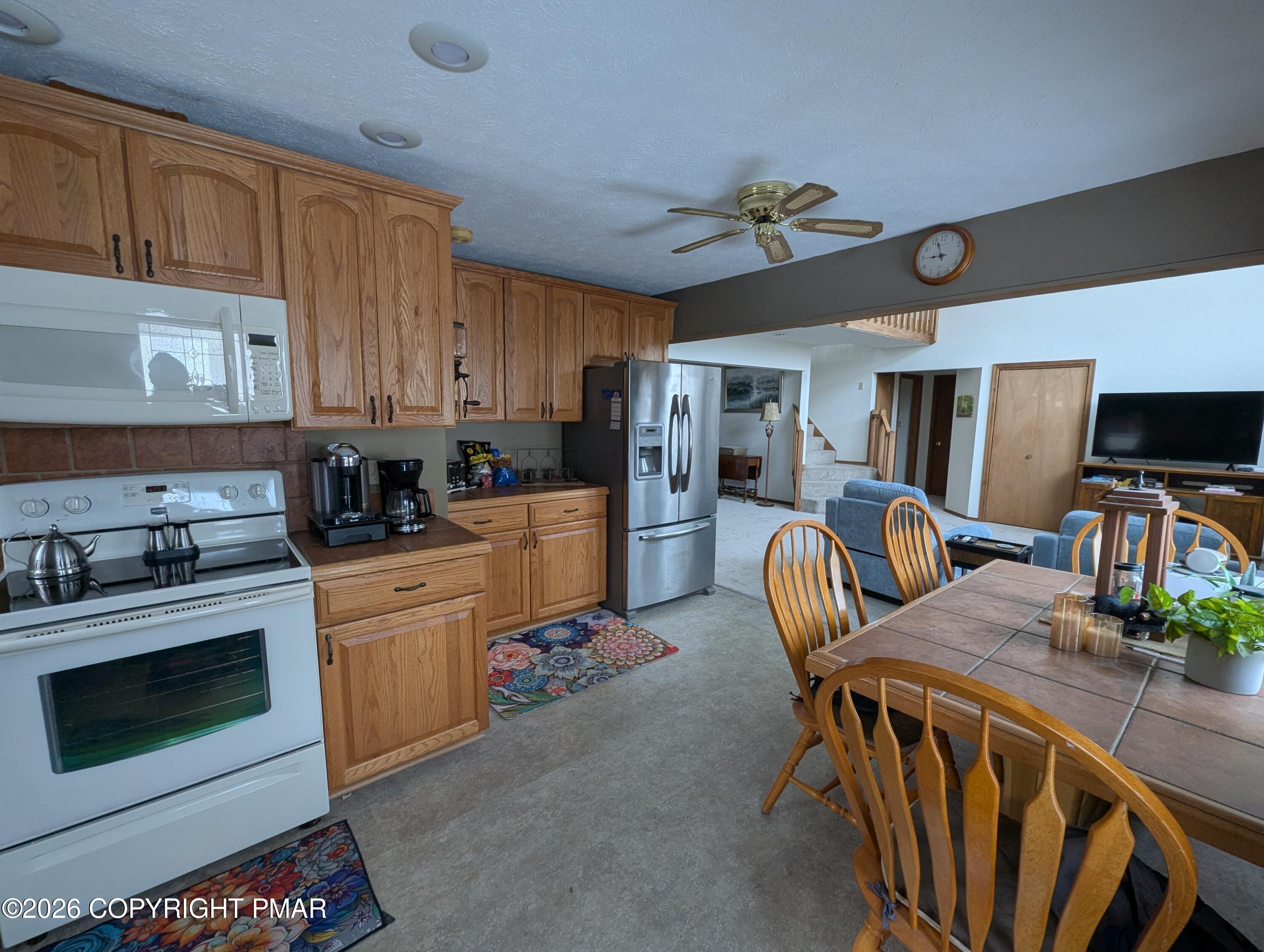 64 High Point Drive, Unit 2232 Lake Ariel, PA 18436 - Photo 7 of 12 a kitchen with stainless steel appliances kitchen island granite countertop a table chairs microwave and sink