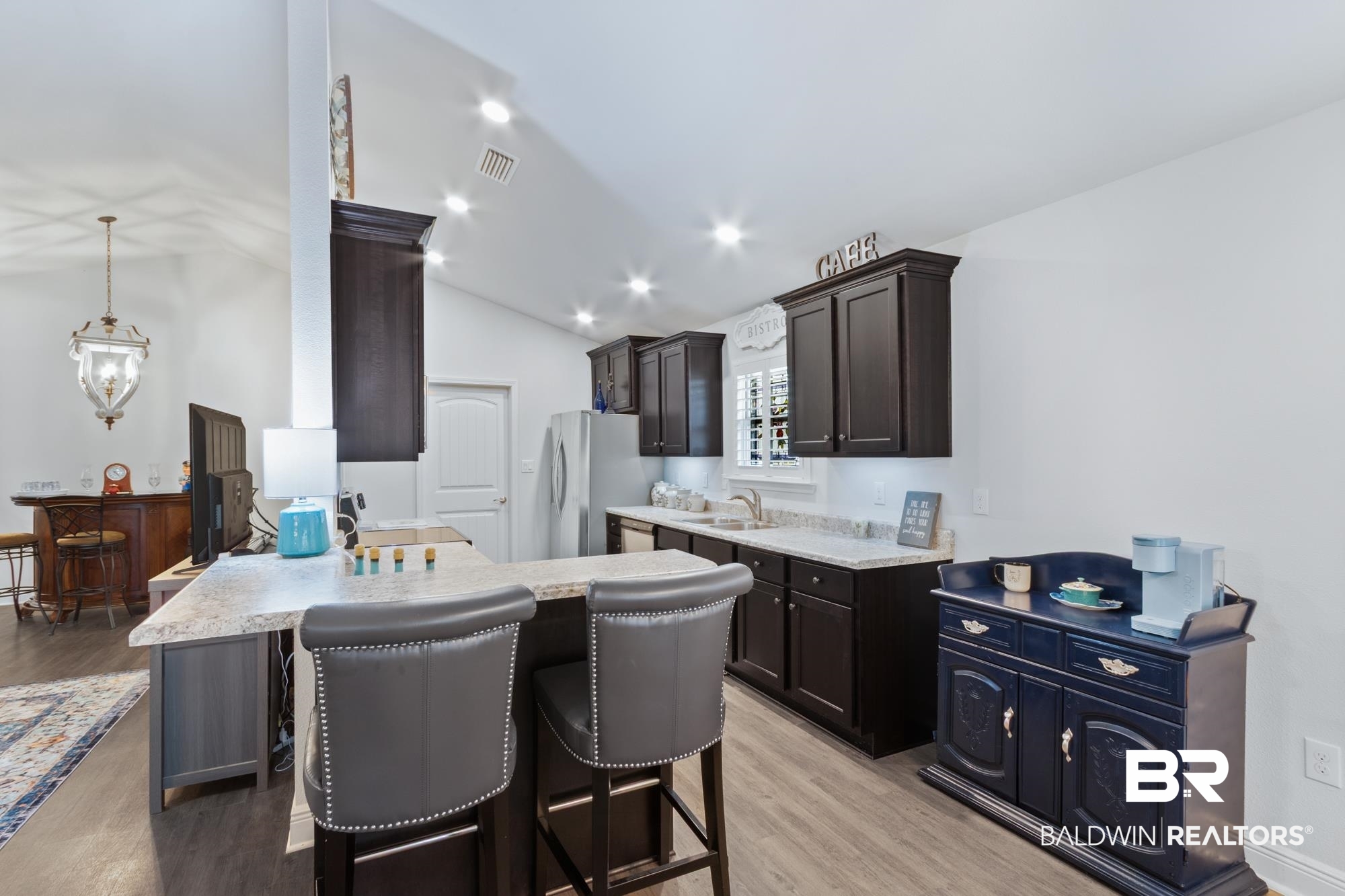 22641 Respite Lane Foley, AL 36535 - Photo 9 of 33 Kitchen featuring light countertops, freestanding refrigerator, lofted ceiling, and a sink
