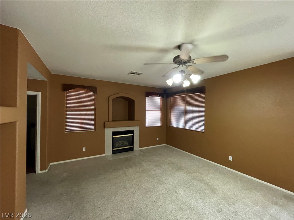 105 Parker Ranch Drive Henderson, NV 89012 - Photo 2 of 12 This living room provides a comfortable setting with a cozy fireplace.
