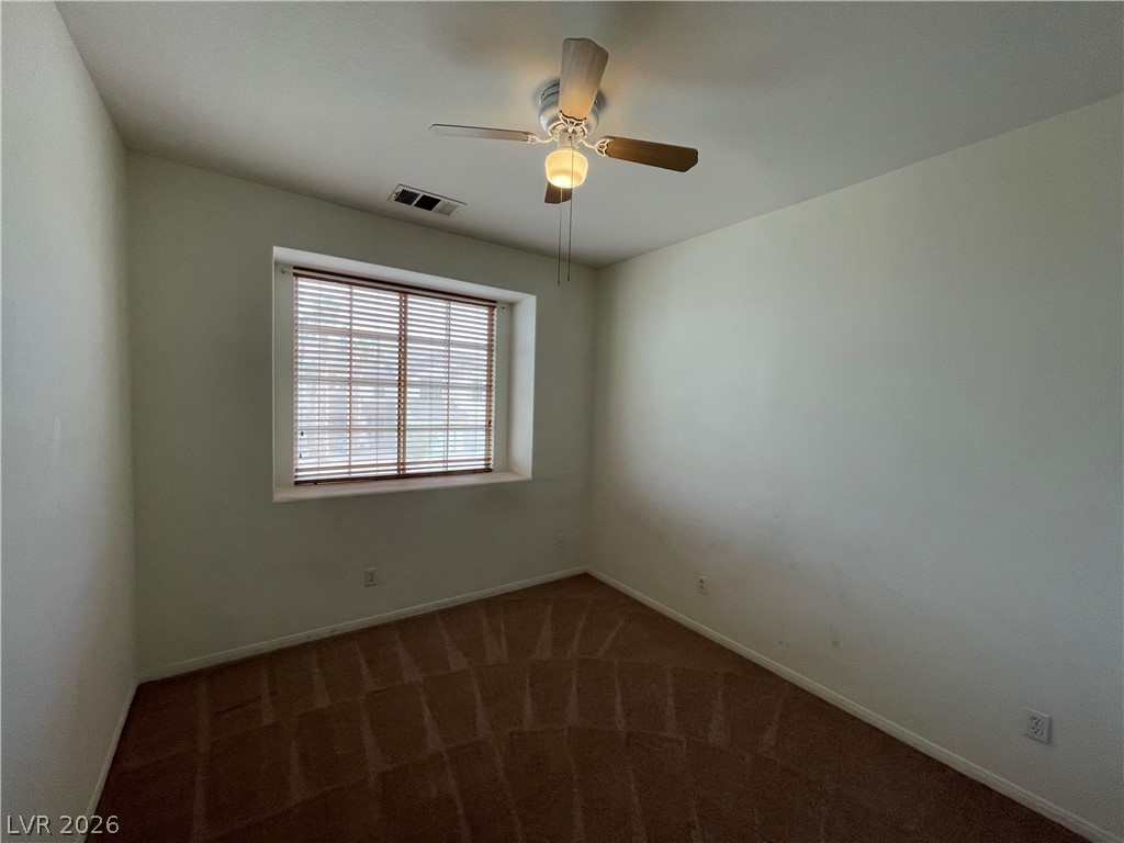 105 Parker Ranch Drive Henderson, NV 89012 - Photo 5 of 12 This cozy bedroom offers a bright window with blinds and a functional ceiling fan.