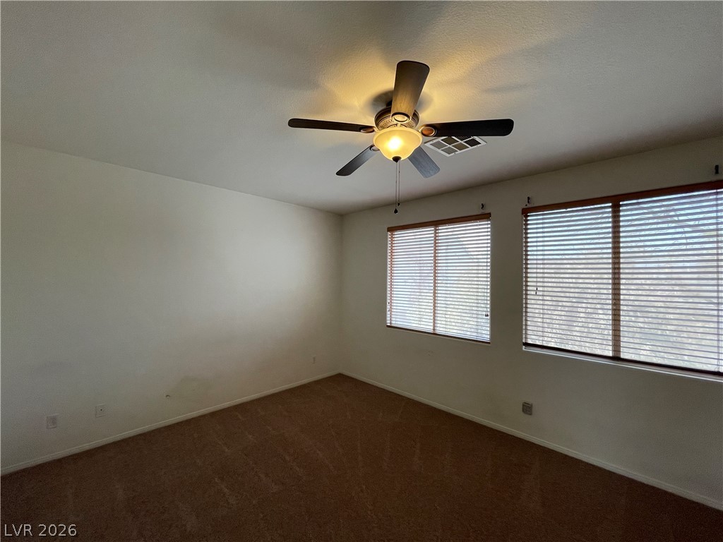 105 Parker Ranch Drive Henderson, NV 89012 - Photo 9 of 12 This airy bedroom offers a comfortable space with ample natural light.