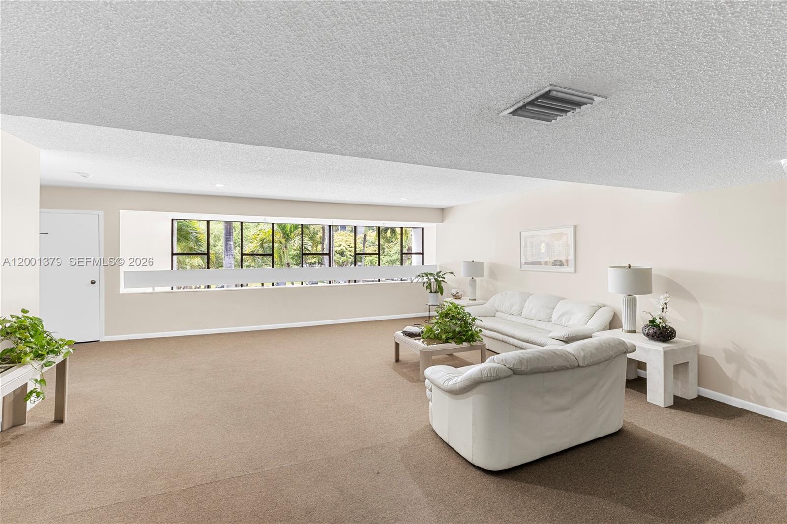 16251 Golf Club Road, Unit 311 Weston, FL 33326 - Photo 7 of 38 a living room with furniture and a large window