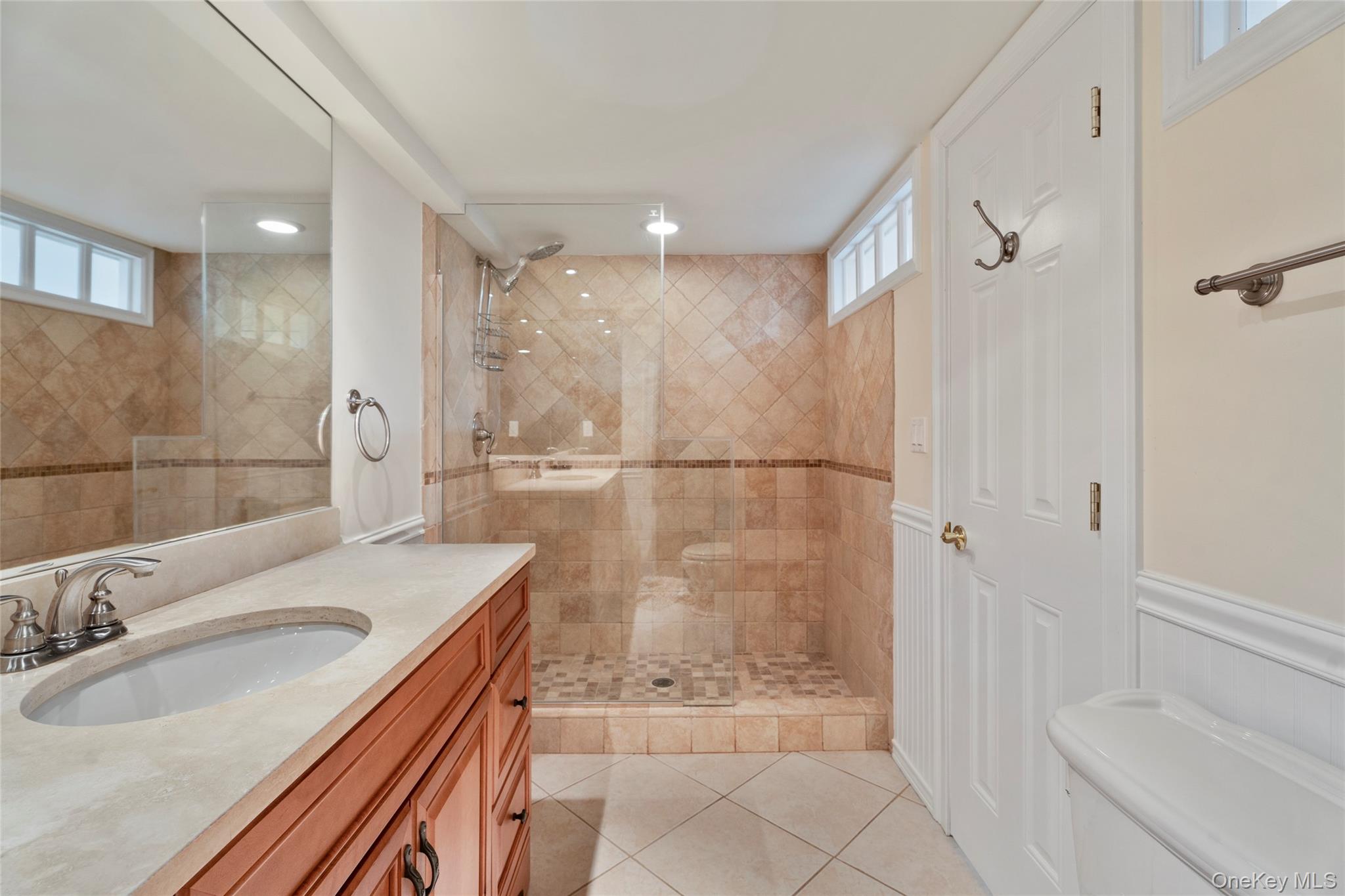 3012 Mitchell Road, Unit 3012 Westhampton Beach, NY 11978 - Photo 12 of 19 a bathroom with a sink a toilet and shower