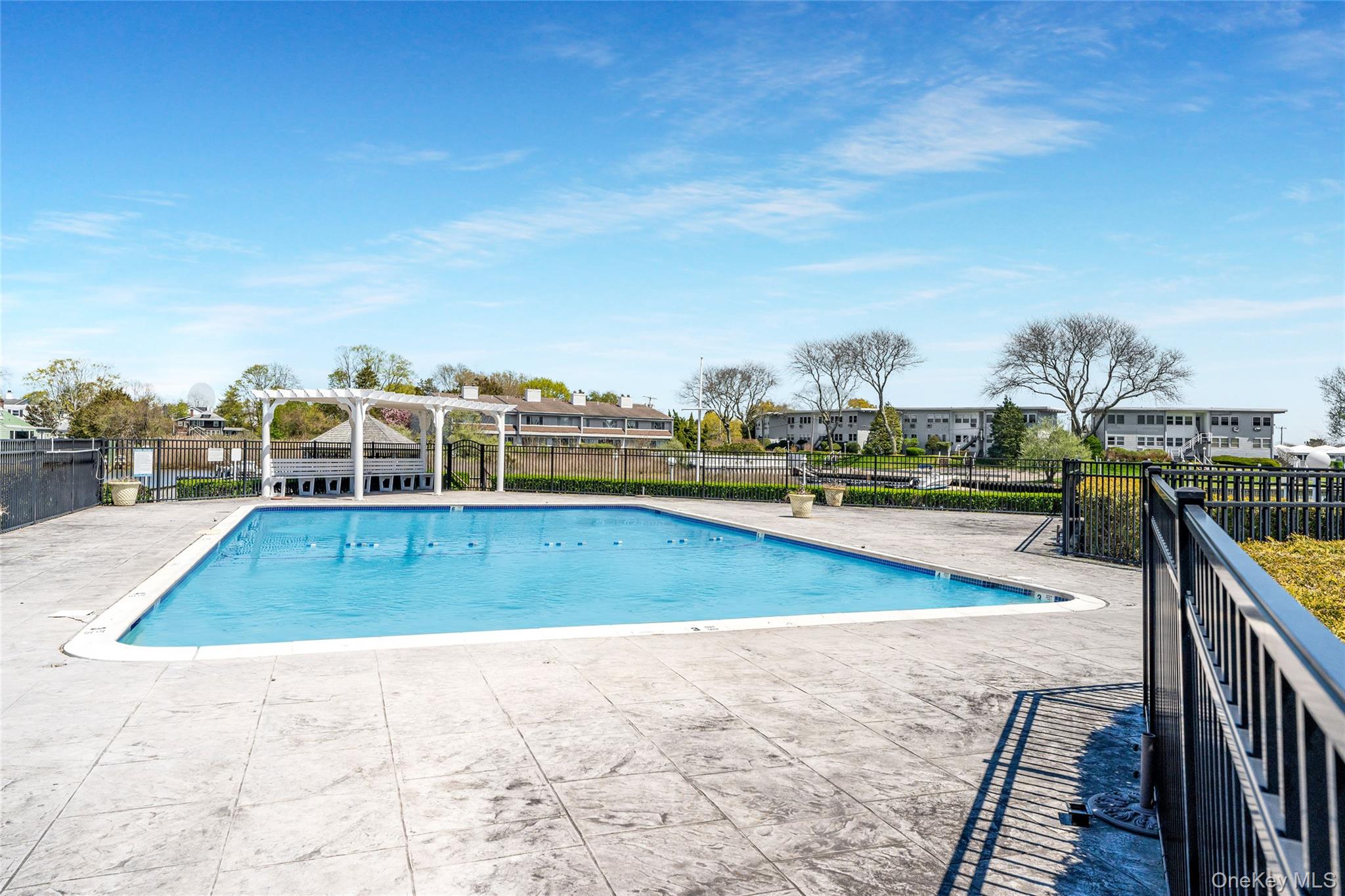 3012 Mitchell Road, Unit 3012 Westhampton Beach, NY 11978 - Photo 15 of 19 a view of a swimming pool with an ocean view