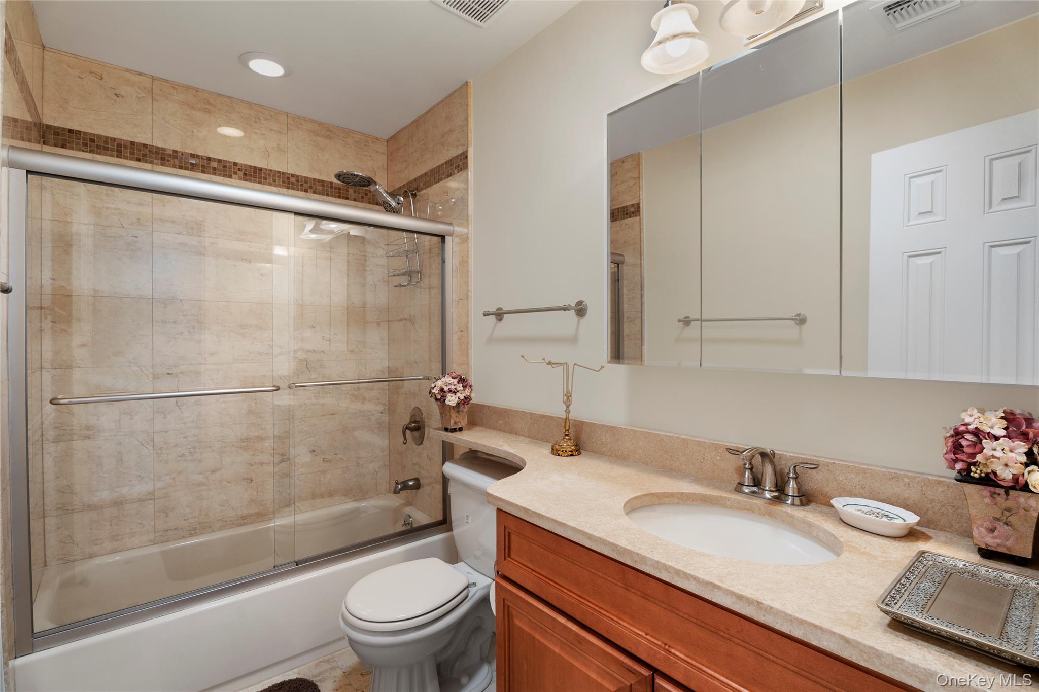 3012 Mitchell Road, Unit 3012 Westhampton Beach, NY 11978 - Photo 10 of 19 a bathroom with a sink a toilet and shower