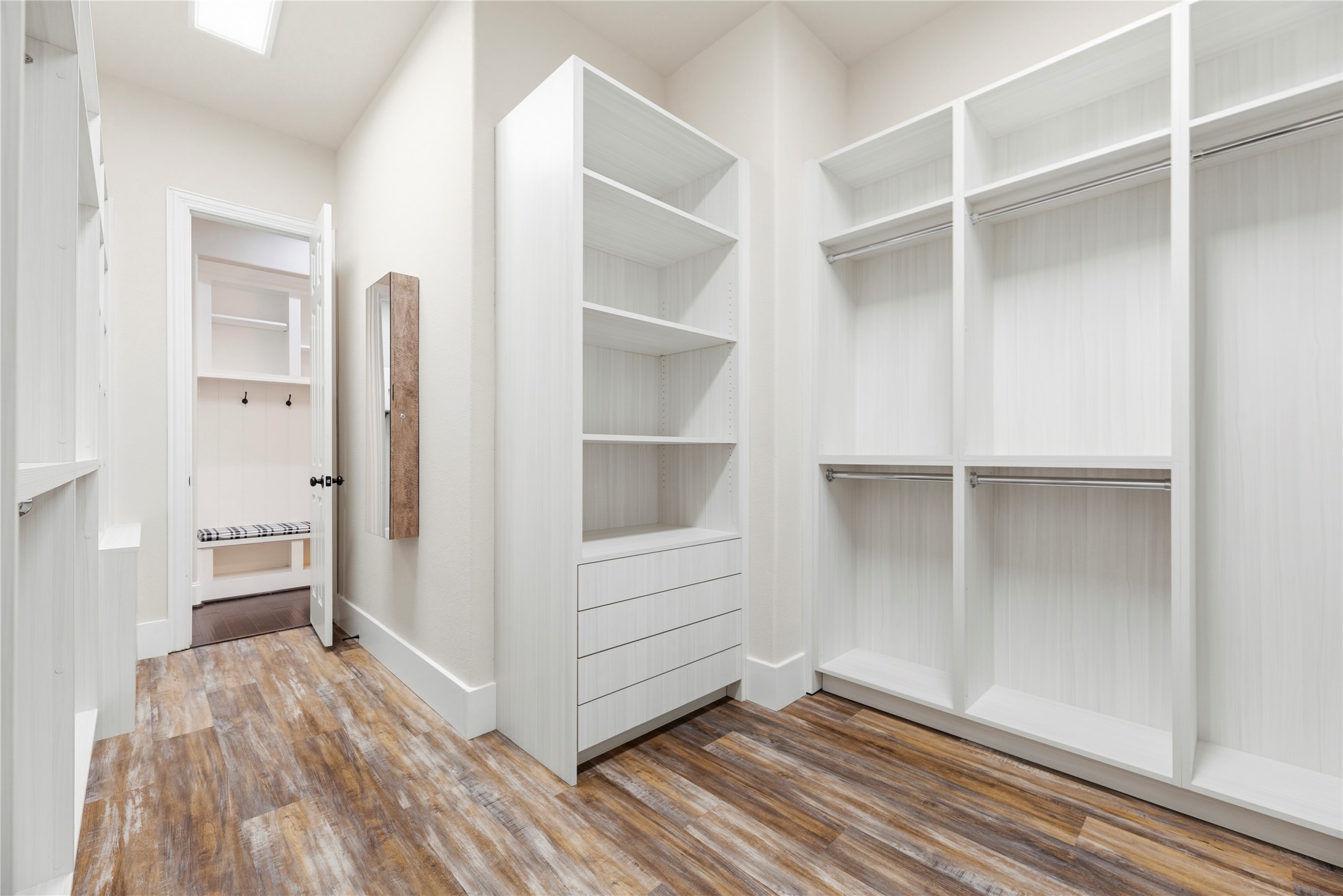 28226 South Firethorne Road Katy, TX 77494 - Photo 19 of 39 This spacious primary closet features extensive shelving, hanging rods, and integrated dresser drawers.
