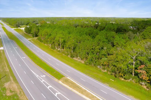 a view of a pool and trees in the background