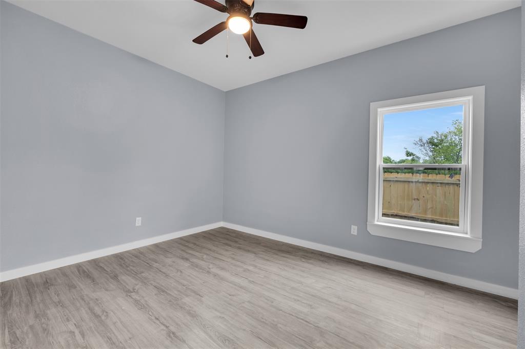 409 Dallas Street Rice, TX 75155 - Photo 21 of 26 a view of an empty room with wooden floor and a window