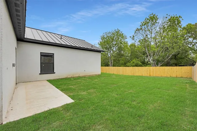 a view of backyard with garage