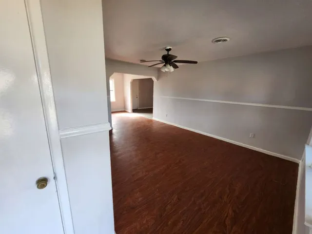 a view of a hallway with a ceiling fan