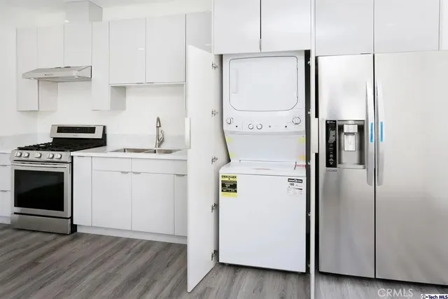 a kitchen with a white cabinets and white appliances