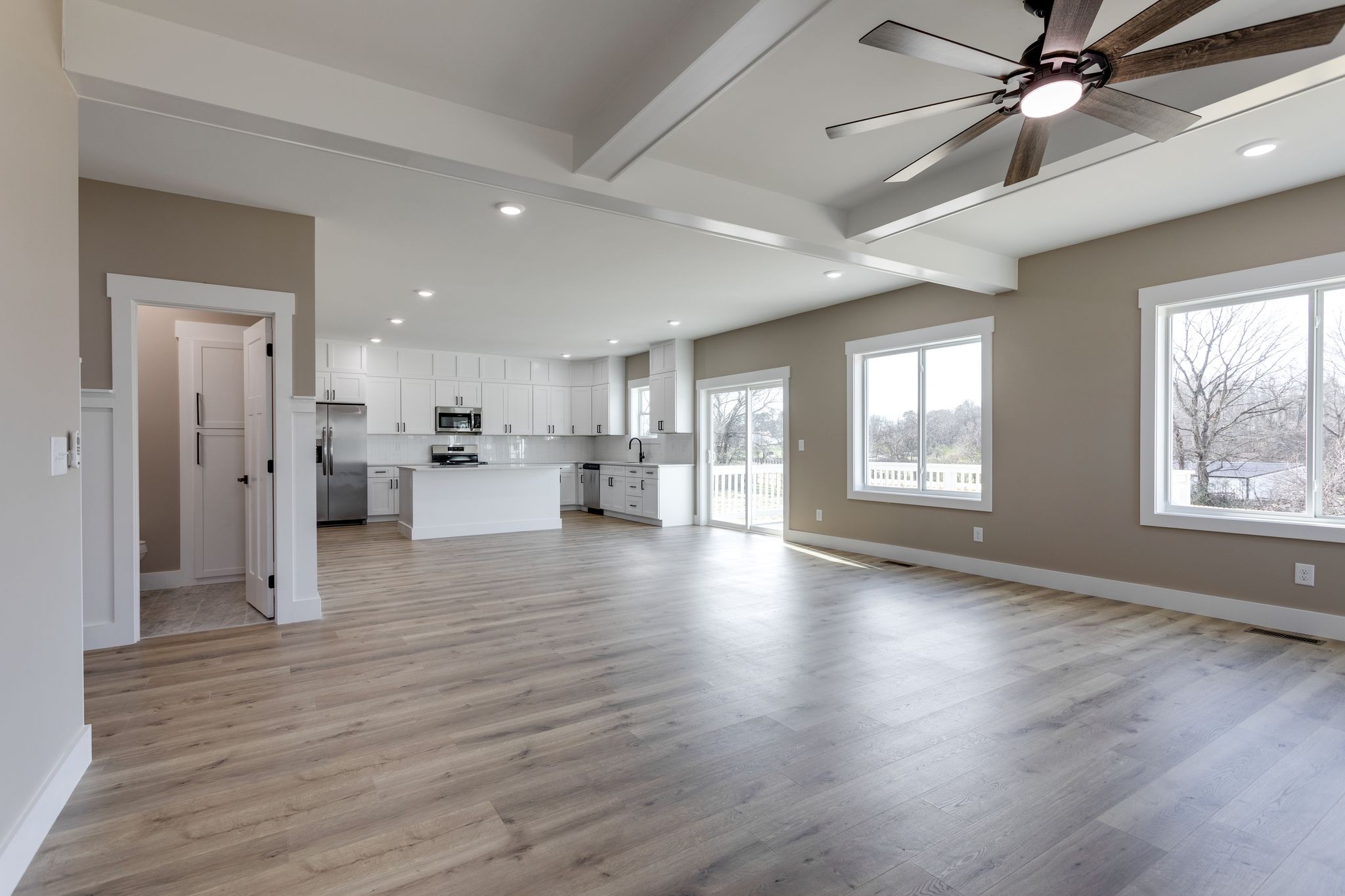 2259 Les Robinson Road Columbia, TN 38401 - Photo 15 of 31 a view of an empty room and kitchen with wooden floor and a window