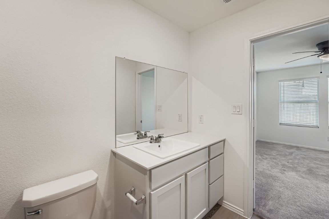 210 Sormonne Loop Kyle, TX 78640 - Photo 11 of 17 a bathroom with a sink toilet and vanity
