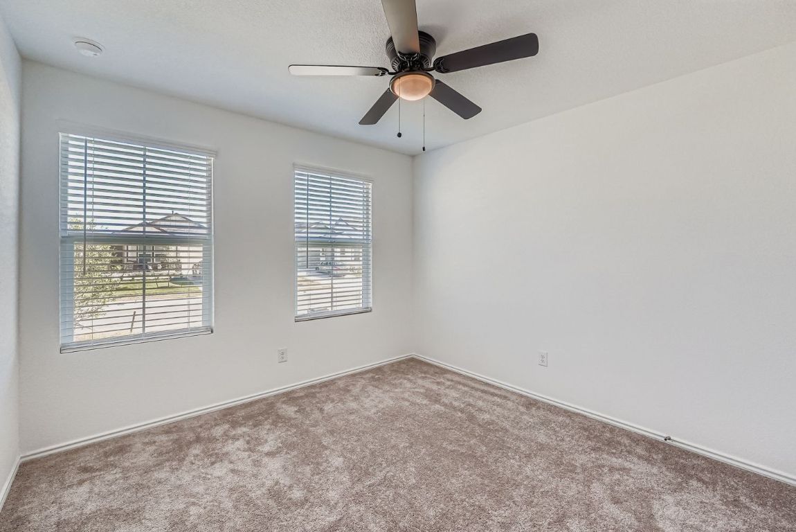210 Sormonne Loop Kyle, TX 78640 - Photo 12 of 17 an empty room with a window and a fan