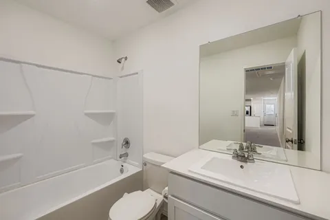 a bathroom with a sink toilet a tub and shower