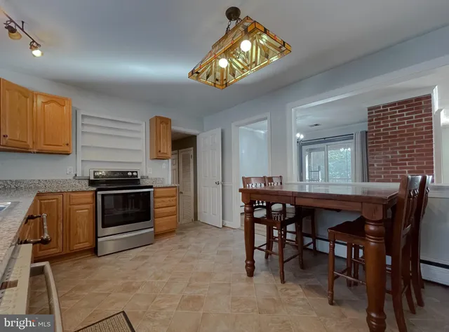 a kitchen with granite countertop a stove and a refrigerator