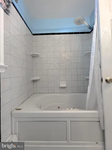 a view of a room with wooden floor and windows