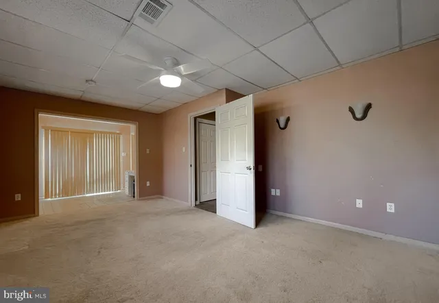 a view of a hallway with a sink and a fireplace