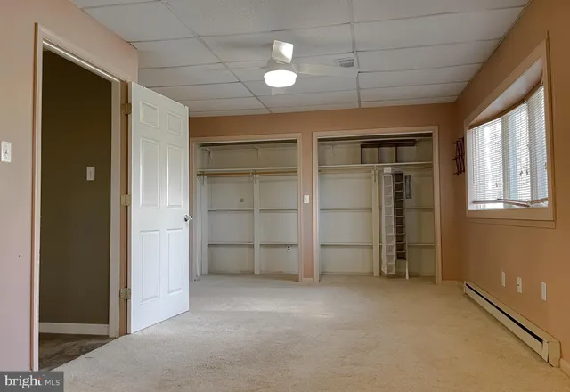 a bathroom with a toilet sink and a mirror
