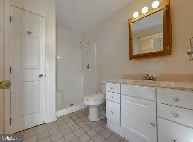 a view of a house with a large tree and a yard