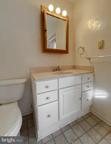 a front view of a house with a floor to ceiling window and potted plants